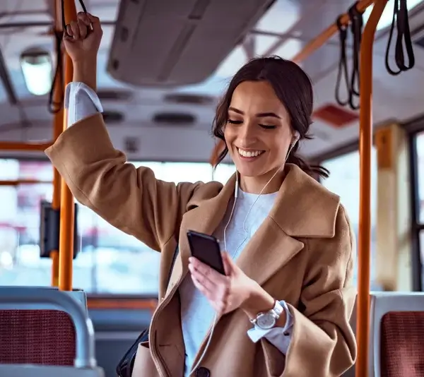 Woman using phone on bus
